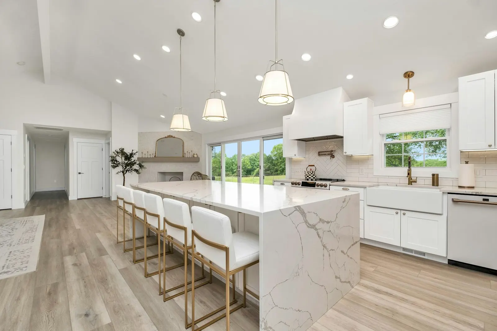 A bright finished kitchen with a marble island