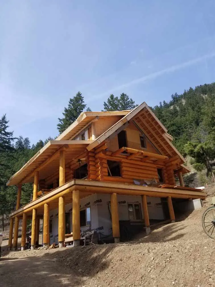 A finished Comark log home on a hillside