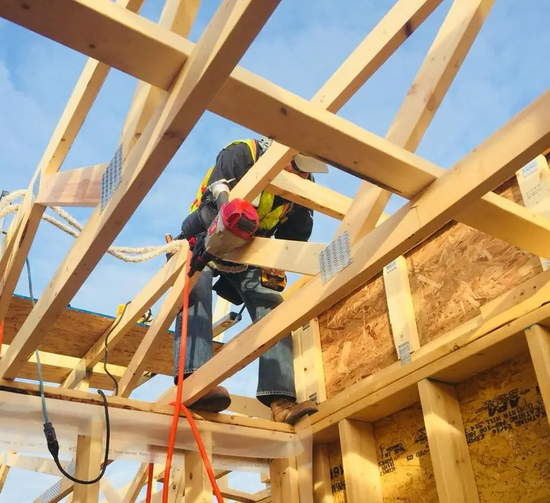 Comark crew setting roof trusses